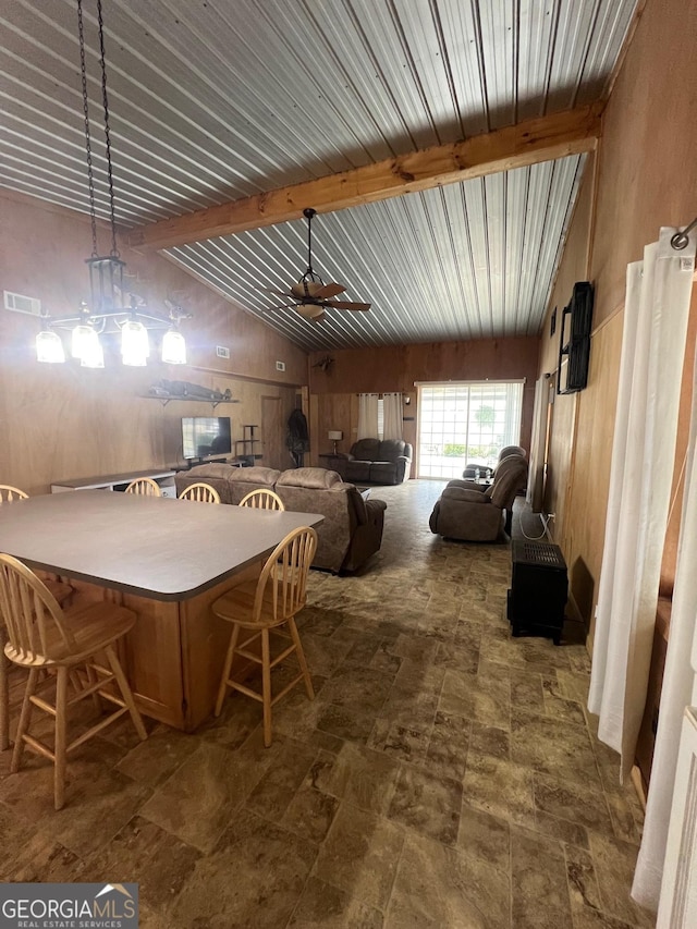 dining area with a ceiling fan, visible vents, and lofted ceiling with beams