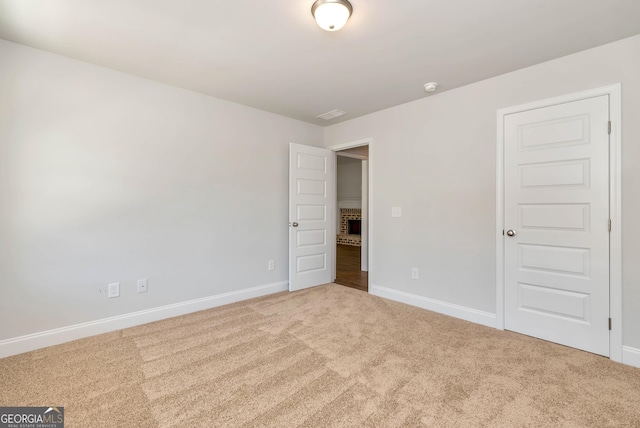 unfurnished bedroom with carpet floors and baseboards