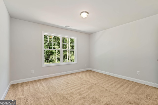 unfurnished room featuring light carpet, baseboards, and visible vents