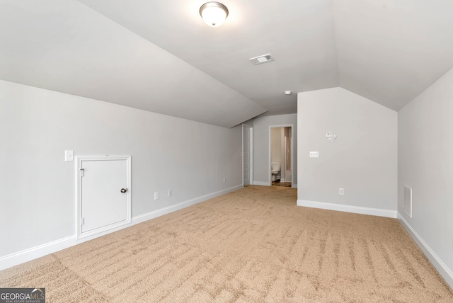 bonus room featuring carpet floors, lofted ceiling, visible vents, and baseboards