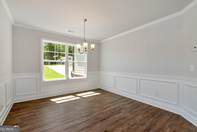 unfurnished dining area with dark wood-type flooring, crown molding, and an inviting chandelier