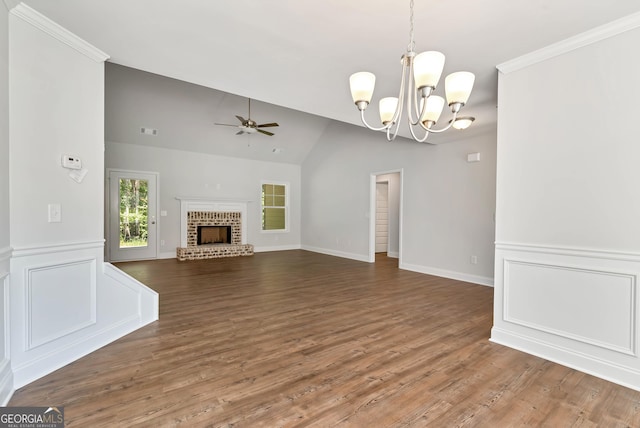 unfurnished living room featuring a fireplace, visible vents, vaulted ceiling, wood finished floors, and ceiling fan with notable chandelier