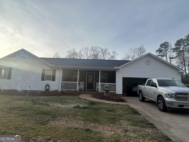 ranch-style home with a garage, covered porch, driveway, and a front lawn