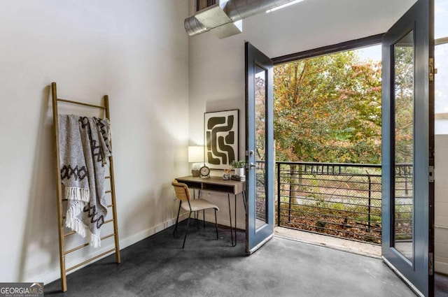 interior space featuring concrete flooring and baseboards