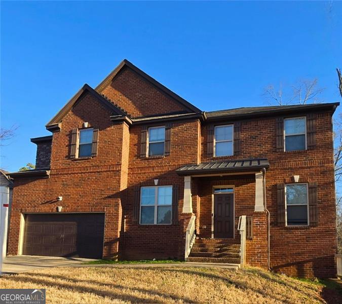 view of front of property with driveway, an attached garage, a front yard, and brick siding