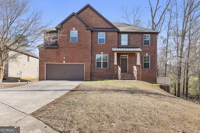 view of front facade with brick siding, an attached garage, and driveway