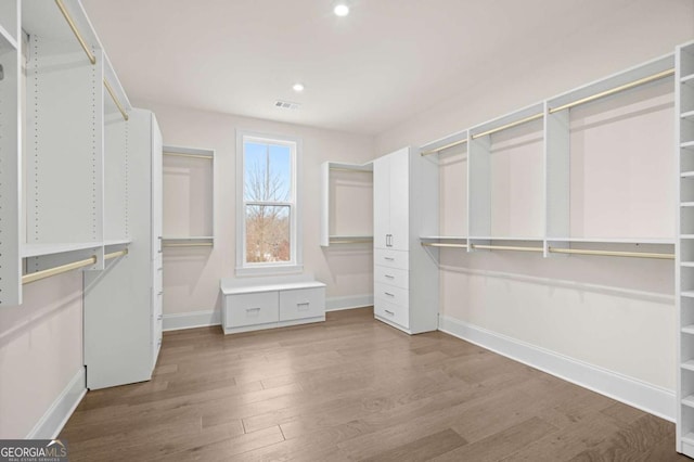 spacious closet featuring visible vents and wood finished floors