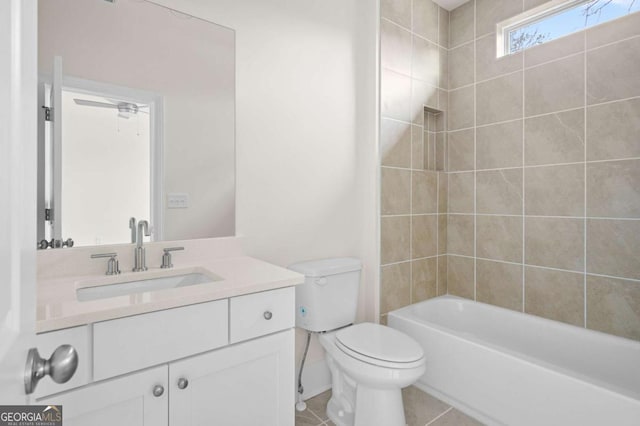 full bath featuring toilet, tile patterned floors, washtub / shower combination, and vanity