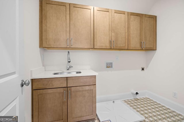 washroom featuring cabinet space, baseboards, a sink, washer hookup, and electric dryer hookup