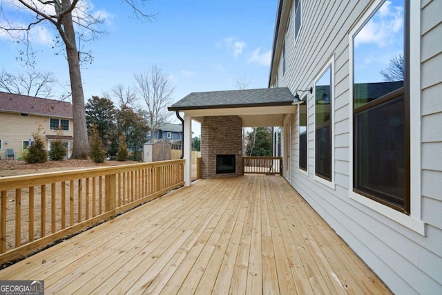 wooden deck with a fireplace