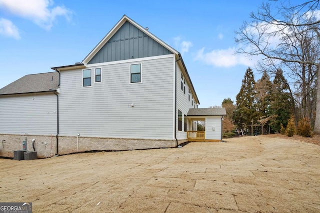 view of home's exterior with cooling unit and board and batten siding