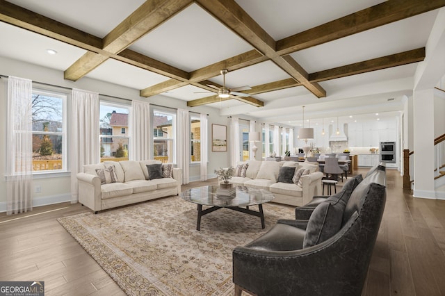 living area featuring wood-type flooring, baseboards, and coffered ceiling