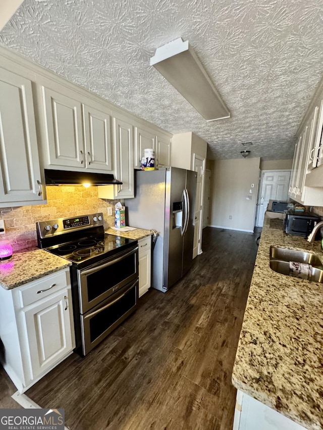 kitchen featuring appliances with stainless steel finishes, white cabinets, and a sink