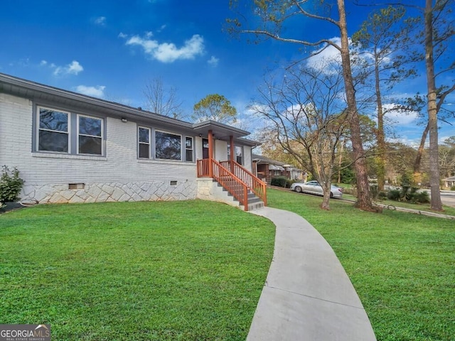 view of front of house with a front yard, crawl space, and brick siding