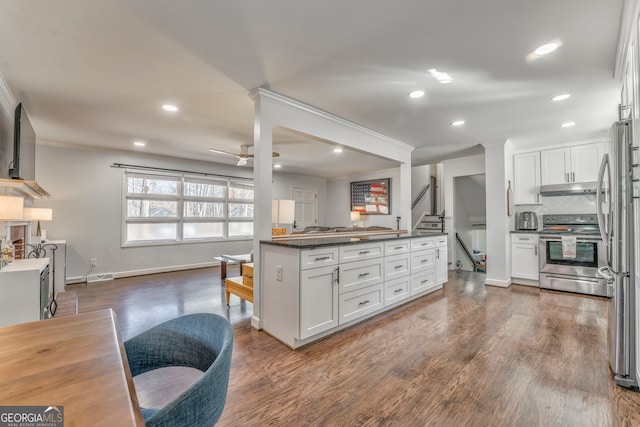 kitchen with white cabinets, dark wood-style floors, appliances with stainless steel finishes, under cabinet range hood, and backsplash