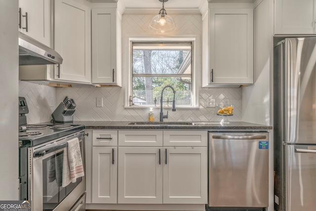 kitchen with decorative light fixtures, stainless steel appliances, white cabinets, a sink, and under cabinet range hood