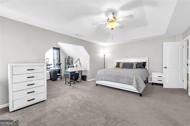 bedroom with light carpet, baseboards, a raised ceiling, ceiling fan, and vaulted ceiling