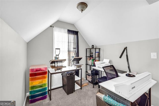 home office featuring light carpet and vaulted ceiling