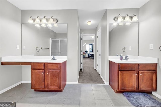 full bathroom with two vanities, a stall shower, tile patterned flooring, and a sink