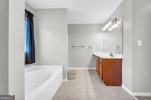 bathroom with a garden tub, tile patterned floors, vanity, and baseboards