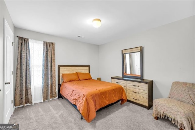 bedroom with light carpet and visible vents