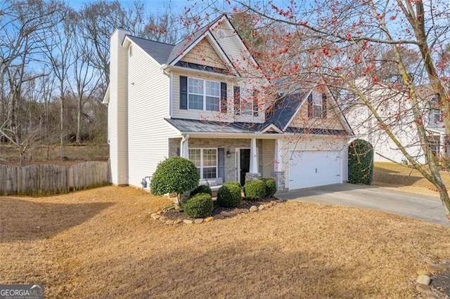 view of front of house with an attached garage, a chimney, fence, and concrete driveway