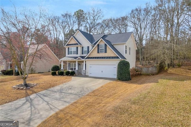 craftsman-style house featuring an attached garage, a standing seam roof, metal roof, driveway, and a front lawn