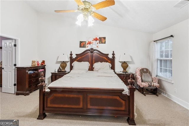 bedroom with light carpet, ceiling fan, visible vents, and baseboards