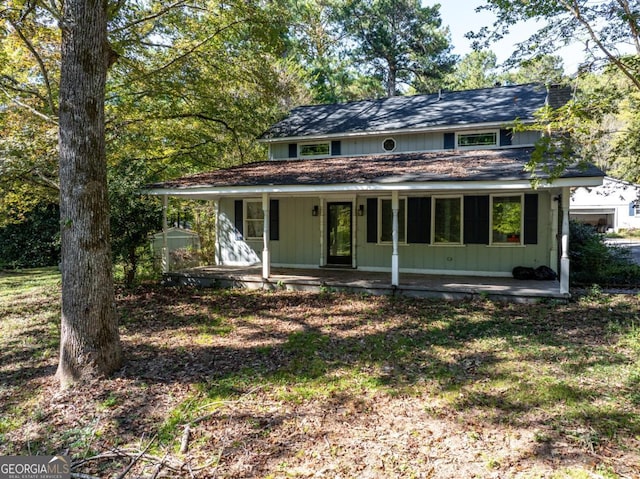 view of front of home with a patio and a storage unit