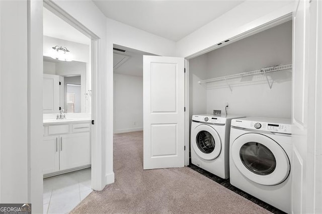 laundry room with laundry area, light colored carpet, a sink, and washing machine and clothes dryer