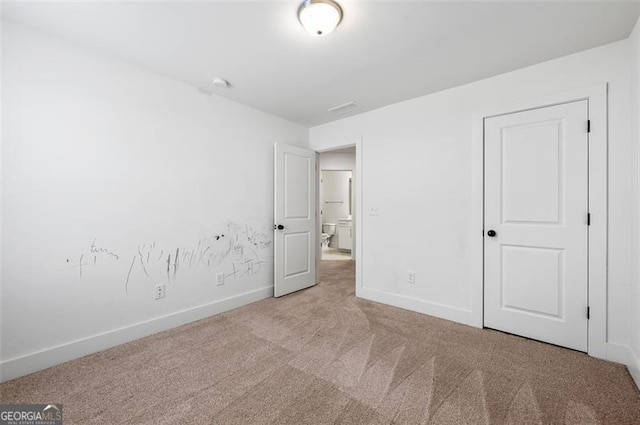 unfurnished bedroom with light carpet and baseboards