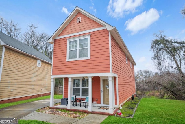 view of front of property with a porch and a front lawn