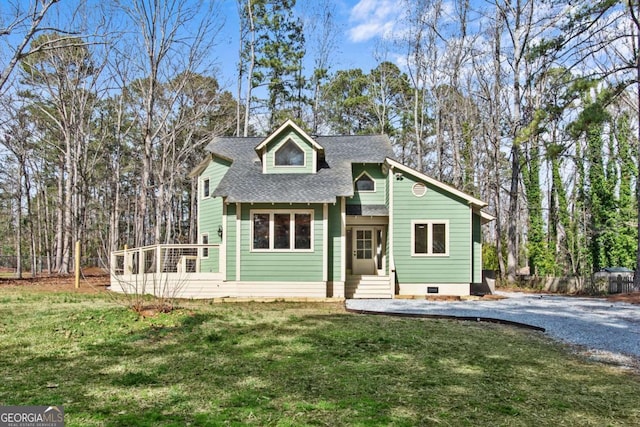 view of front of property with a shingled roof and a front yard