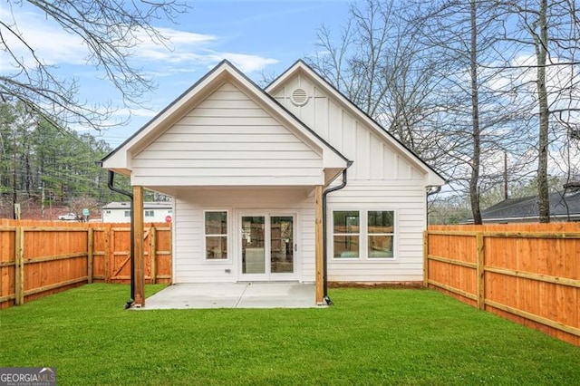 395 Lake Ave, Atlanta, GA 30318 - rear view of property featuring a fenced backyard, a patio area, board and batten siding, and a lawn