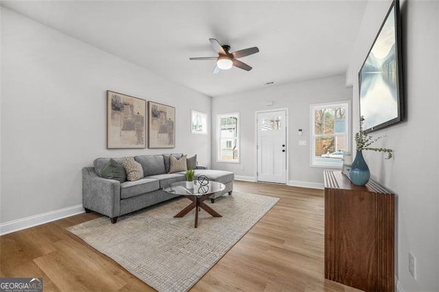 395 Lake Ave, Atlanta, GA 30318 - living room featuring light wood-style floors, a ceiling fan, and baseboards