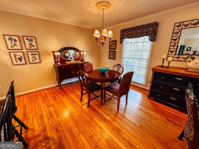 dining area with an inviting chandelier, baseboards, light wood finished floors, and crown molding