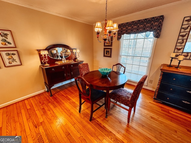 dining area featuring baseboards, an inviting chandelier, light wood-style flooring, and crown molding