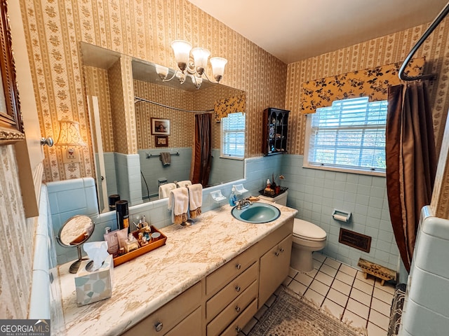 full bath with curtained shower, toilet, wainscoting, tile patterned floors, and wallpapered walls