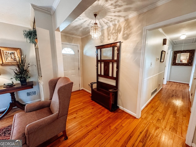 foyer with light wood-style floors and crown molding