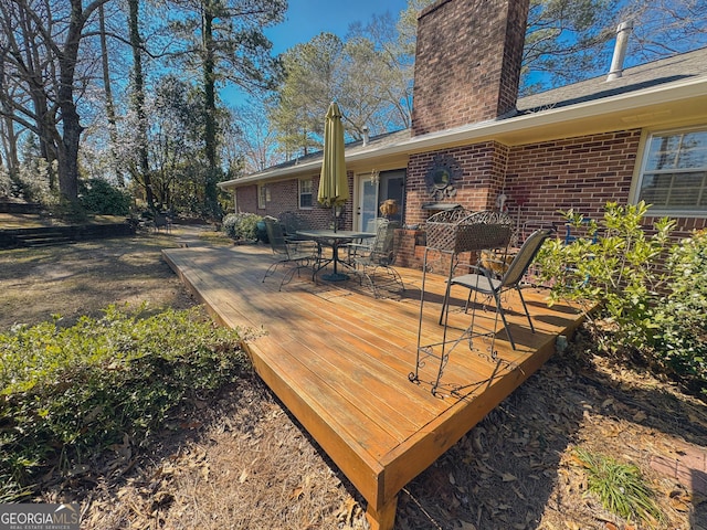 deck with outdoor dining area