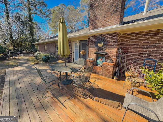 wooden deck featuring outdoor dining area