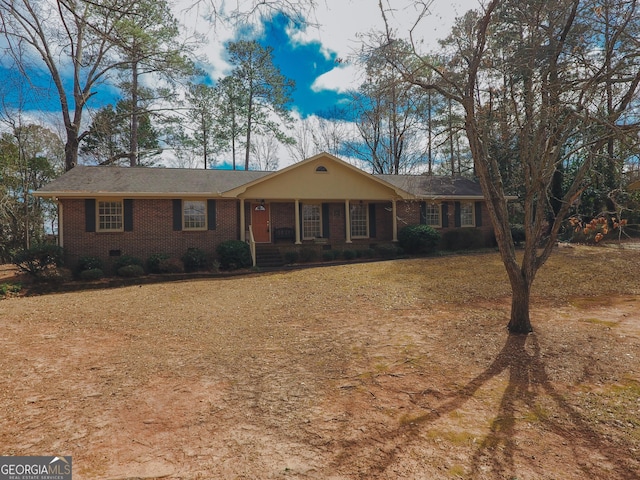 ranch-style home featuring brick siding and crawl space