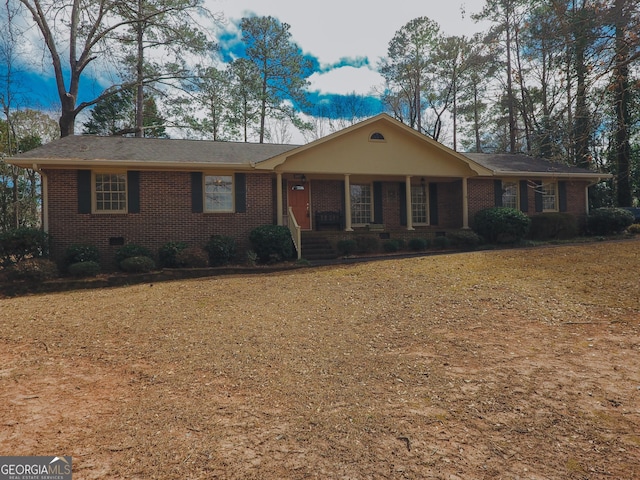 ranch-style home featuring crawl space, brick siding, and a front lawn