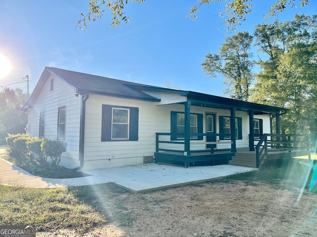 view of front of property with a porch and a patio