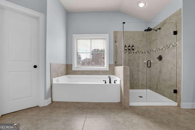 full bath with vaulted ceiling, a stall shower, tile patterned flooring, and a bath