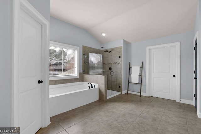 bathroom with baseboards, a garden tub, tile patterned flooring, vaulted ceiling, and a shower stall