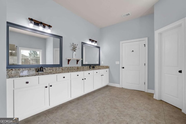 full bathroom featuring double vanity, tile patterned flooring, visible vents, and a sink