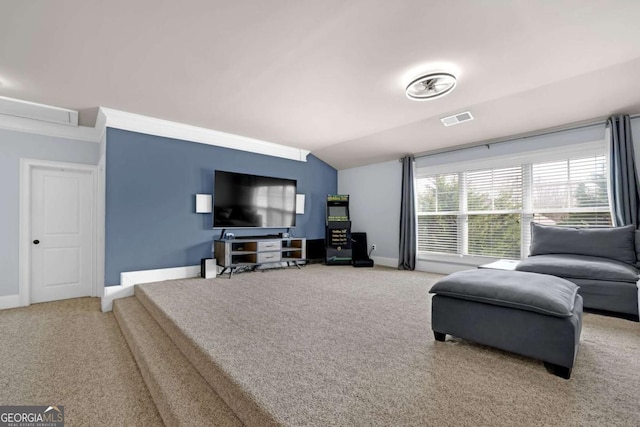 carpeted living area with visible vents, vaulted ceiling, and baseboards