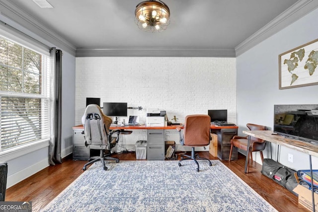 office space featuring a healthy amount of sunlight, wood finished floors, and crown molding