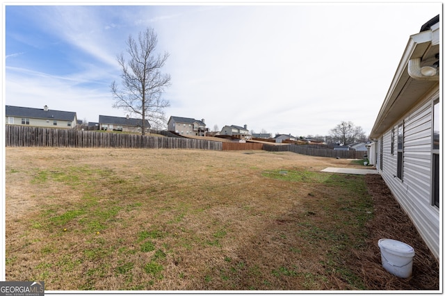 view of yard featuring a residential view and a fenced backyard